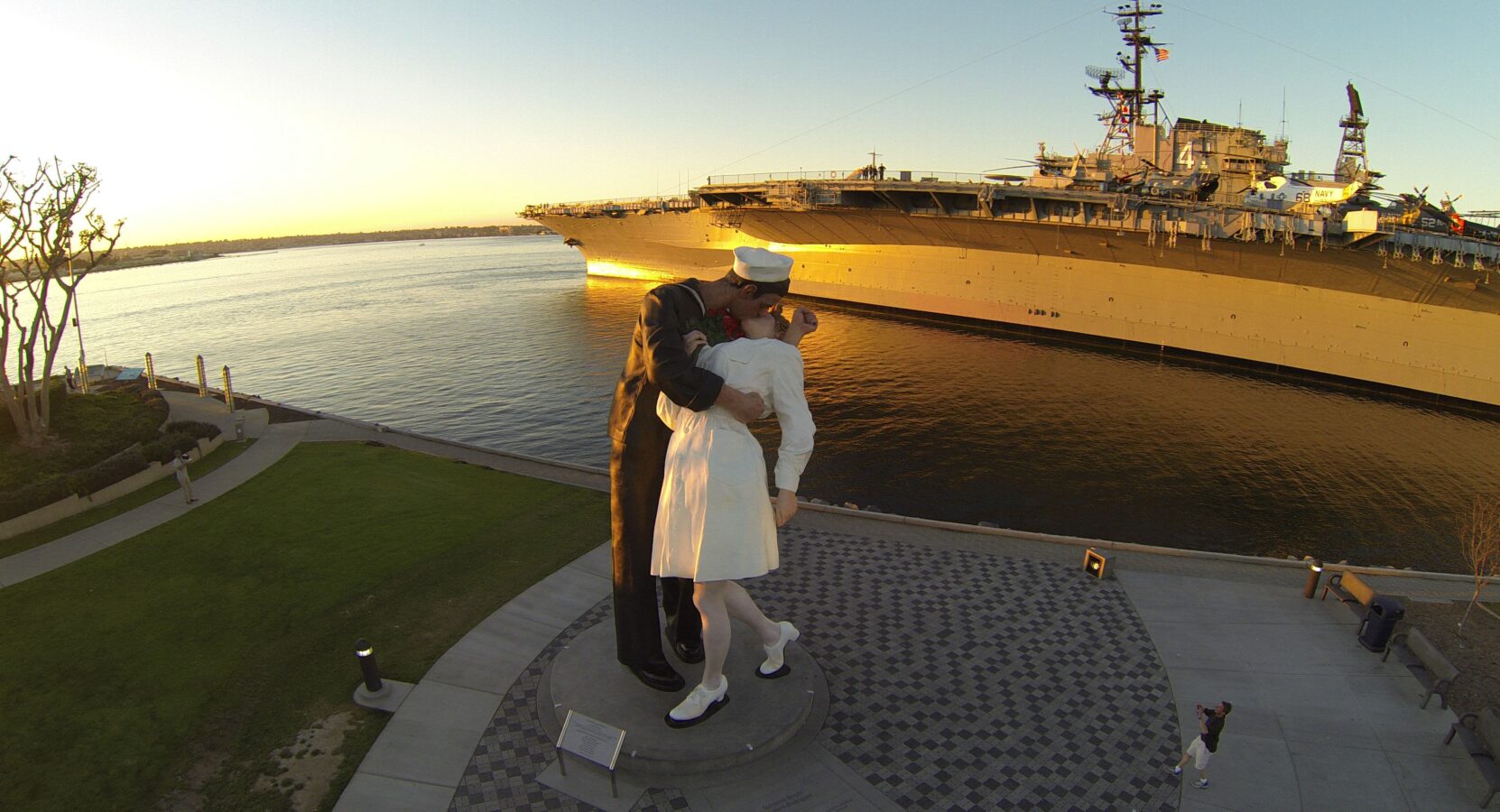 Sailor Kissing Nurse next to the USS Midway Museum at Sunset