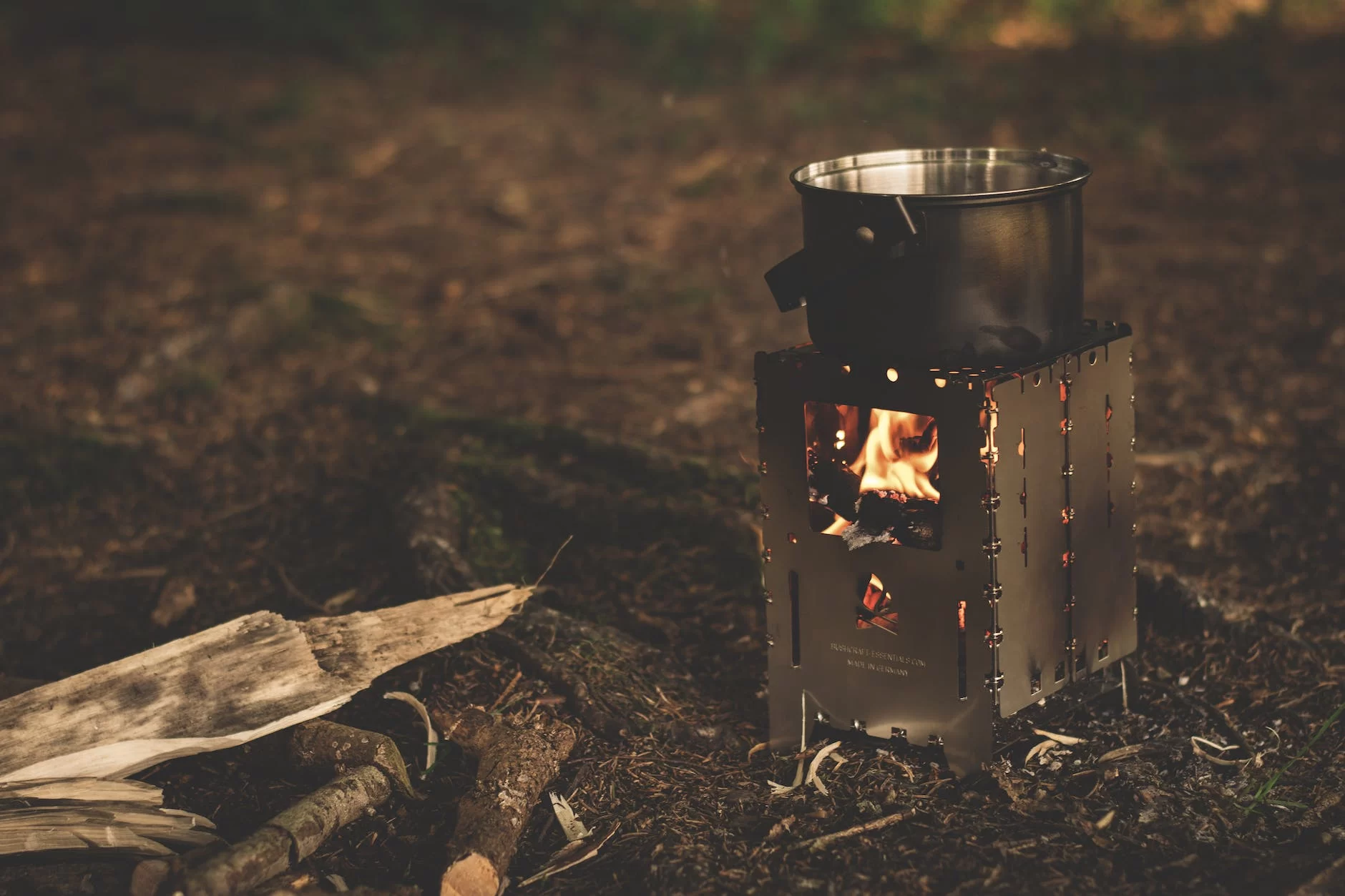 Camping Wood Stoves for Backpacking stainless steel pot on brown wood stove outside during night time